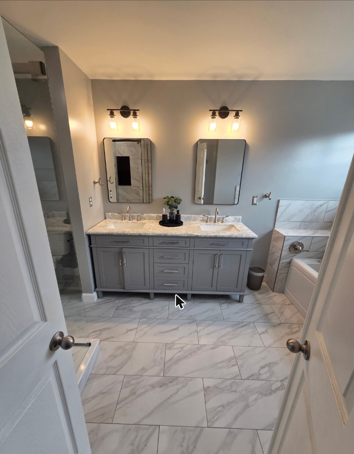Bathroom remodel with double vanity and marble tile floor in Grasonville, MD — Assured Contracting Company