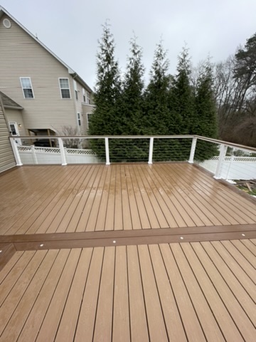 Composite deck with white cable railing in Grasonville, MD — Assured Contracting Company