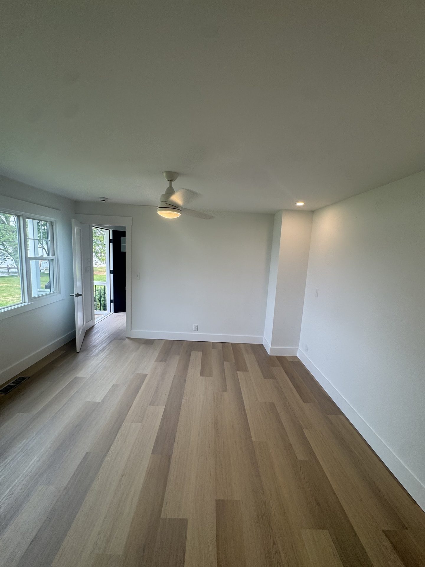 Home addition with bright living space and vinyl plank flooring in Grasonville, MD — Assured Contracting Company