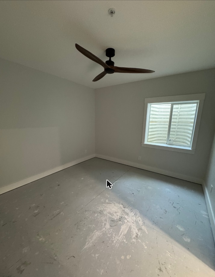 Finished basement bedroom with ceiling fan in Grasonville, MD — Assured Contracting Company
